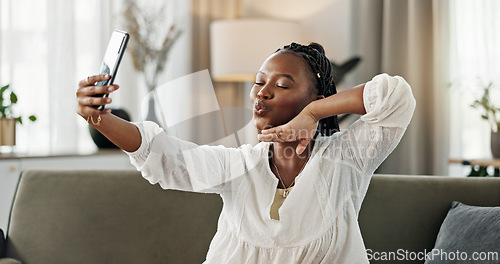 Image of Smile, selfie and black woman with peace sign, funny face and relax on sofa in living room. V hand, picture and happy African person or influencer at home on couch on social media with tongue out