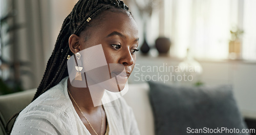 Image of Stress, doubt and black woman on sofa, thinking and worry with mental health in apartment living room. Frustrated, anxiety and girl sitting on couch with fear, depression and debt trauma in home.