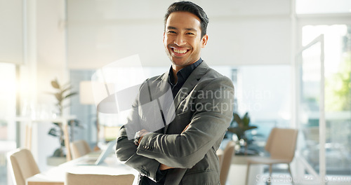 Image of Crossed arms, happy and business Asian man in office for leadership, empowerment and success. Corporate, manager and portrait of person with funny joke in workplace for ambition, pride and confidence