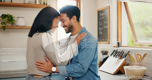 Image of Love, hug and couple in a kitchen happy, together and intimate while bonding in their home. Embrace, romance and man with woman hugging, smile and sharing moment of trust, care or soulmate connection