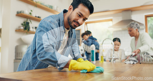 Image of Family, cleaning and man in a kitchen with cloth for table, hygiene or clean living space after dinner. House, disinfection and guy parent with household chore for safety from bacteria, dirt or germs