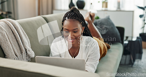 Image of Black woman on sofa, relax or typing on laptop for remote work, social media or blog post research with smile in home. Happy girl on sofa with computer checking email, website or online chat in house