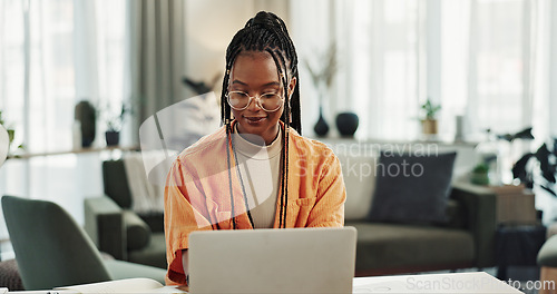 Image of Black woman, typing in home office and laptop for remote work, social media or blog research in apartment. Freelance girl at desk with computer writing email, website post and online chat in house.