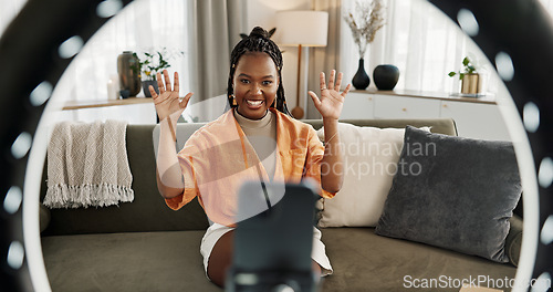 Image of Wave, live streaming and happy black woman with box or product in home living room. Hello, influencer and person with package, record video on social media and content creation, ring light and phone