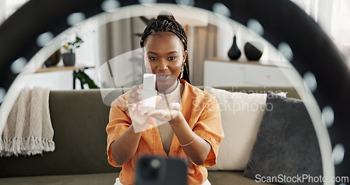 Image of Smile, live streaming and black woman with serum for beauty and open skincare box. Happy, influencer and cosmetics, review product and content creation on social media, ring light and phone at home