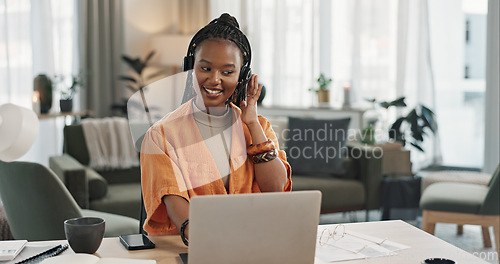 Image of Black woman, headset in home office with laptop and phone call, remote work and crm in apartment. Virtual assistant at desk with computer, typing and conversation for advice, online chat and support