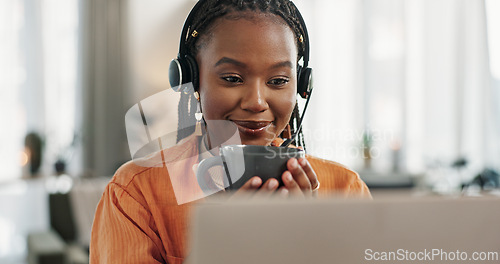 Image of Black woman, headset and coffee in home office with laptop and remote work and break in apartment. Virtual assistant at desk with computer, drink and relax with freelancer, consultant or crm agent.