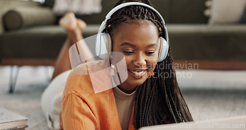 Image of Home, smile and black woman with a headphones, streaming music or sound in a living room. African person on a sofa, apartment or girl with headset, listening to audio or relax with happiness or song