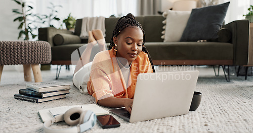 Image of Laptop, education and a student black woman on the floor of a living room to study for a test or exam. Computer, smile and a happy young person learning with an online course for upskill development