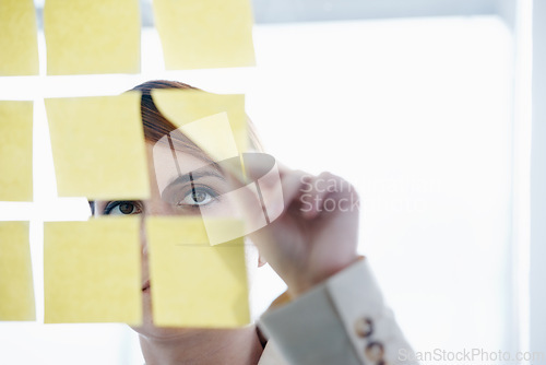 Image of Employee, sticky notes and glass wall for logistics, thinking and vision for planning and ideas. Businesswoman, brainstorming and mockup for meeting, goals and teamwork for project management