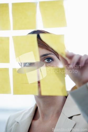 Image of Businesswoman, sticky notes and glass wall for ideas, planning and vision for logistics and schedule. Employee, brainstorming and management for meeting, goal and seo with decisions for marketing