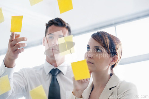 Image of Business people, glass wall and sticky note with conversation, collaboration and planning. Brainstorming for a project, cooperation and schedule with staff, meeting and agency with startup and ideas