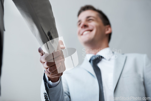 Image of Low angle, businessman and shaking hands with partner, colleague and smile for deal or promotion. Man, consult and hand for contract agreement, interview and advice for agency and office partnership