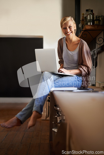 Image of Woman in kitchen, laptop and remote work, smile in portrait and writer for blog, freelancer and copywriting. Working from home, website development and writing article, editor or journalist with tech