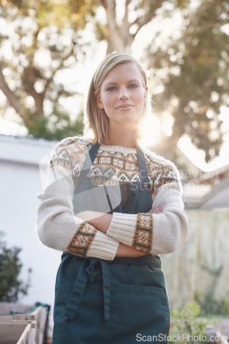 Image of Gardening, crossed arms and portrait of woman with plants for landscaping, planting flowers and growth. Agriculture, nature and person for outdoor environment, ecology or nursery in garden in morning