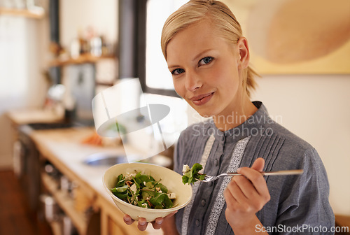 Image of Woman, portrait and salad eating in kitchen or health nutrition for wellbeing, ingredients or fibre. Female person, face and bowl or vegetable meal in apartment for diet leafy greens, food or Canada