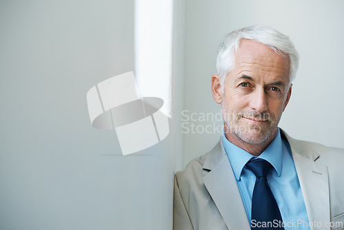 Image of Portrait, mature man and corporate in suit with copy space, confidence and serious look with determination at office. Businessman, executive and professional with experience, wisdom and success.
