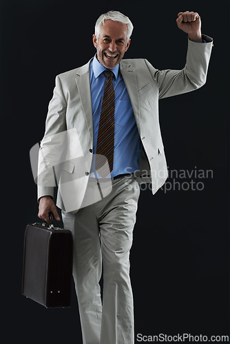 Image of Excited, portrait and senior businessman with suitcase in studio, celebration or winner fist on black background. Travel, success and elderly entrepreneur face with yes hands for opportunity or deal