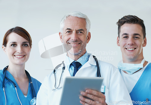 Image of Tablet, smile and portrait of doctor with nurses in hospital for medical diagnosis or treatment discussion. Team, digital technology and senior surgeon with healthcare workers for surgery in clinic.