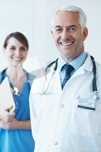 Image of Happy, portrait and senior doctor with nurse in hospital with clipboard for medical research in collaboration. Smile, checklist and mature male surgeon with healthcare worker in clinic for teamwork.