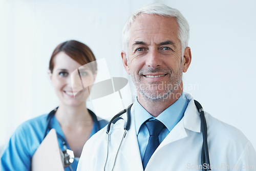 Image of Smile, portrait and doctor with nurse in hospital with clipboard for medical research in collaboration. Happy, checklist and senior male surgeon with healthcare worker in clinic for teamwork.