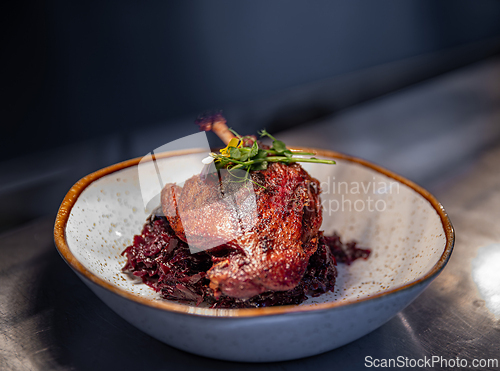 Image of Roast duck leg served with red cabbage