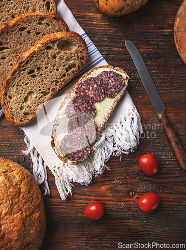 Image of Slice bread with butter and salami
