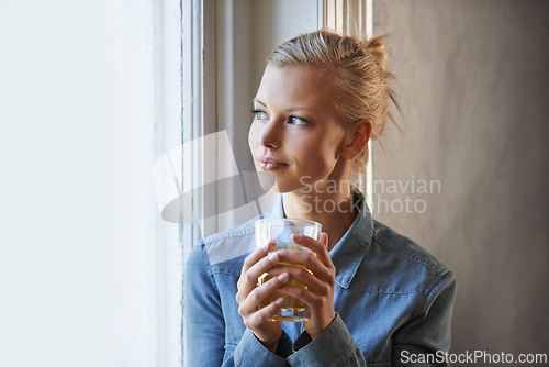 Image of Smile, thinking and woman with coffee in a house for peaceful, reflection or moment at home. Remember, face and female person with happy memory, tea or enjoying me time or weekend at apartment window