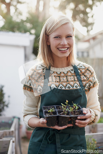Image of Garden, happy and portrait of woman with plants for landscaping, planting flowers and growth. Agriculture, nature and person with seedlings outdoors for environment, ecology and gardening in nursery