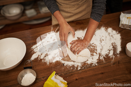 Image of Hands, dough and flour on table in kitchen, bakery for bread or pizza with meal, catering and cooking. Culinary, chef or baker person with pastry preparation, ingredients and food for nutrition
