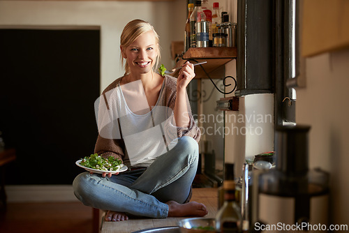 Image of Woman, kitchen and salad with wellness, portrait and home for nutrition, vegetables and diet. Designer, house and lunch for health, smile and relaxation and break for wellbeing, rest and happiness