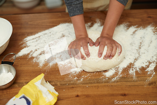 Image of Hands, dough and flour on table at bakery, bread or pizza with meal prep, catering and cooking. Culinary experience, chef or baker person with pastry preparation, ingredients and food for nutrition