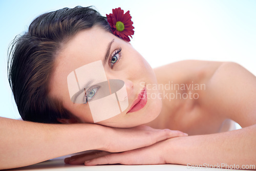 Image of Portrait, skincare or woman with beauty, skincare or natural glow relaxing while isolated on studio background. Model, face and wellness with dermatology, cosmetics and facial products with flower