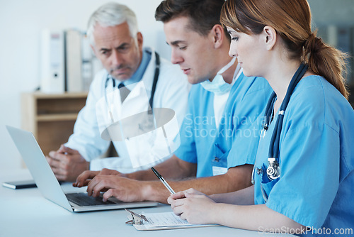 Image of Computer, meeting and doctor with nurses in hospital for medical diagnosis or treatment discussion. Team, laptop and senior surgeon talking to healthcare workers for surgery research in clinic.