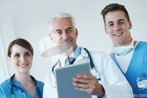 Image of Tablet, meeting and portrait of doctor with nurses in hospital for medical diagnosis or treatment discussion. Team, digital technology and surgeon talking to healthcare workers for surgery in clinic.