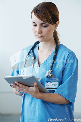 Image of Research, tablet and woman nurse in hospital for medical diagnosis or treatment information. Professional, nursing and young female healthcare worker with digital technology in medicare clinic.