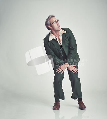 Image of Retro, fashion and man dancing in studio happy attitude, fun and groovy suit on mockup space. Funky clothes, playful and mature person with vintage style, unique and excited on white background.