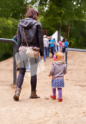 Image of Festival, queue and mother with daughter in forest for event, party or social gathering outdoor in summer. Family, kids and woman parent with girl child in nature, park or woods together from back