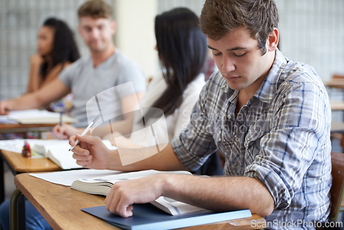 Image of University, book and man in class reading with ambition for development in learning, opportunity and future. Education, knowledge and growth for college student in lecture, studying for exam or test.