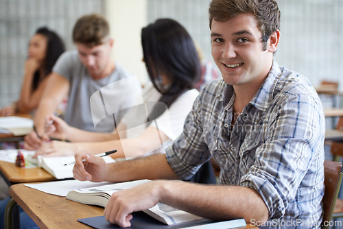 Image of University, books and portrait of man in classroom with development in learning, opportunity and future. Education, knowledge and growth for college student in lecture, studying for exam or test.