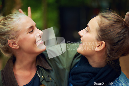 Image of Women, happy and smile in forest for connection, bonding and unity outdoors together in nature. Female friends, gaze and affection in woods for walk, socialising and adventure with joy in Australia