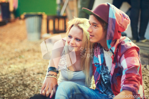 Image of Couple, teenager and music at concert, festival and performance while bonding in Australia. Trendy, teen and youth on date as sitting outside with smile, happiness and love at punk, show and live gig