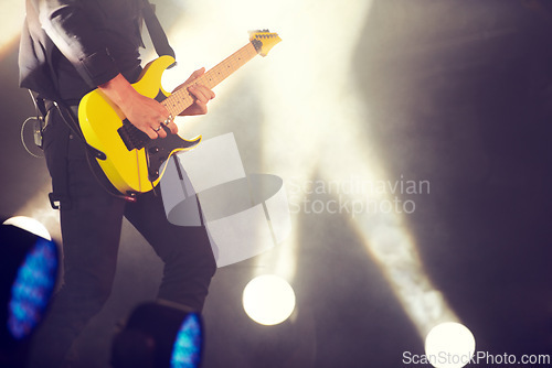 Image of Guitar, stage and man at music festival, concert or live event in Amsterdam. Musician, artist and electric instrument with lights and playing for audience, crowd or spectators at night for enjoyment