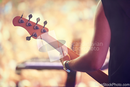 Image of Man, festival and guitar at stage for concert, performance and back view in Amsterdam. Closeup of male musician, standing and playing instrument at live event for crowd, audience and enjoyment