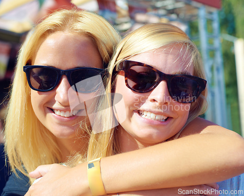 Image of Portrait, concert and women with sunglasses, hug and smile with happiness or music festival. Face, people or outdoor with friends or eyewear with weekend break or excited with embrace with summer fun