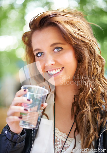 Image of Portrait, smile and woman with drink at music festival, bokeh or celebration outdoor. Face, happy or girl with beverage at party, alcohol and beauty of young female person on summer holiday in France