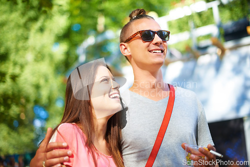 Image of Hug, smile and couple at music festival outdoor, event and celebration on valentines day together in summer. Cigarette, man and happy woman at party, carnival and laugh in nature with drink at park