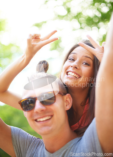 Image of Portrait, piggyback and smile of couple with peace sign at music festival, event and celebration on valentines day together in summer. Face, man and happy woman with v hand gesture at party outdoor