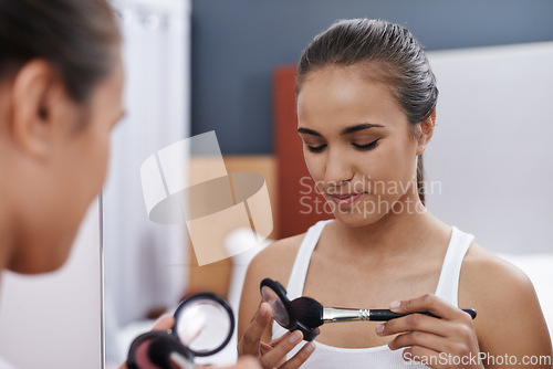 Image of Woman, makeup and mirror for date, cosmetic or interview for fashion artist. Female, blush and eyeshadow for beauty, self care and foundation in bedroom to prepare for graduation and after party