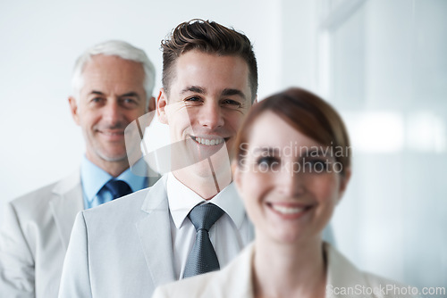 Image of Smiling , friendly group of three businesspeople , and of different age private company staff posing for office portrait. Diverse business partners , team of colleagues professionals working office